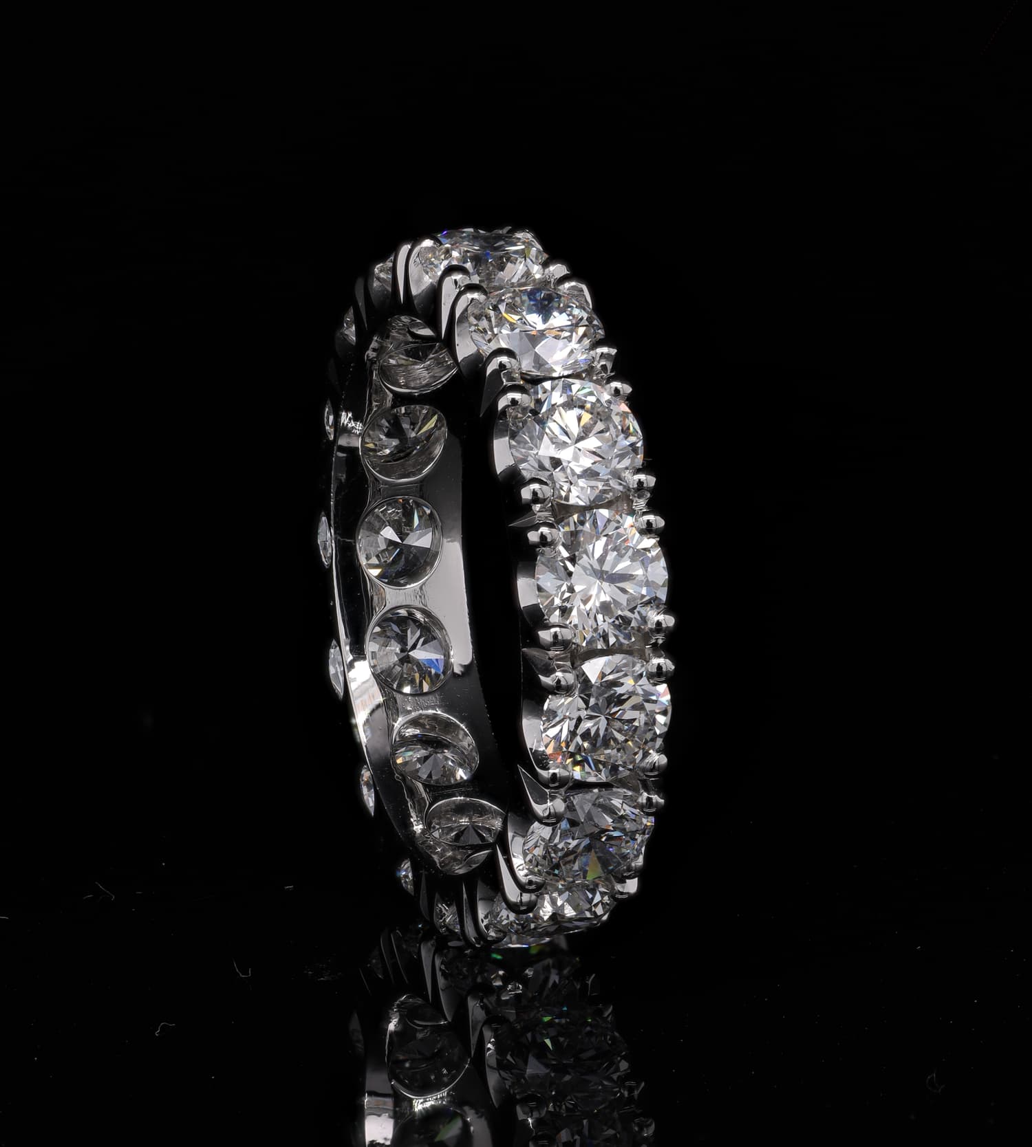 Diamond-set ring photographed against a neutral studio background.